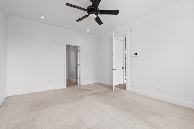 spare room with recessed lighting, light carpet, a ceiling fan, baseboards, and crown molding