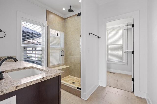 bathroom featuring a stall shower, tile patterned flooring, plenty of natural light, and vanity