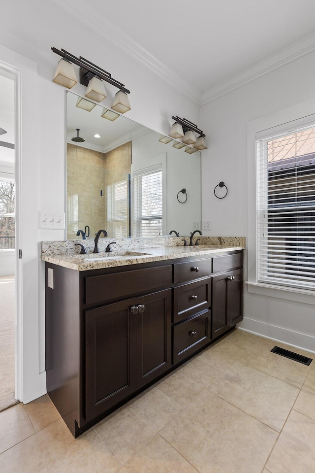 bathroom with double vanity, visible vents, ornamental molding, a sink, and tile patterned flooring