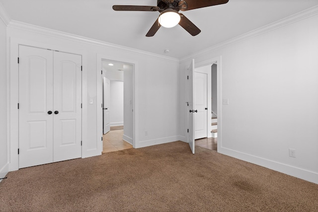 unfurnished bedroom featuring light carpet, ornamental molding, and baseboards