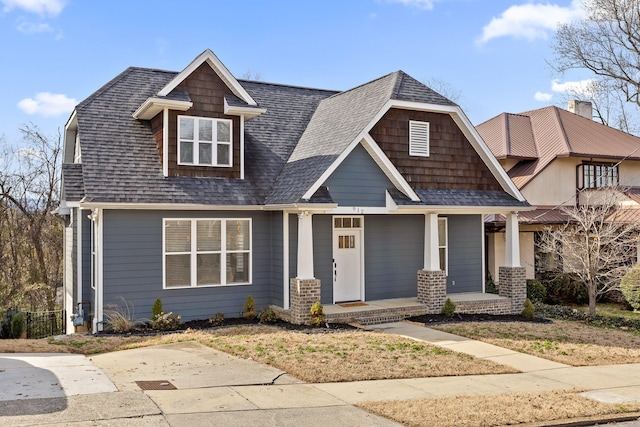 view of front of home with covered porch and roof with shingles