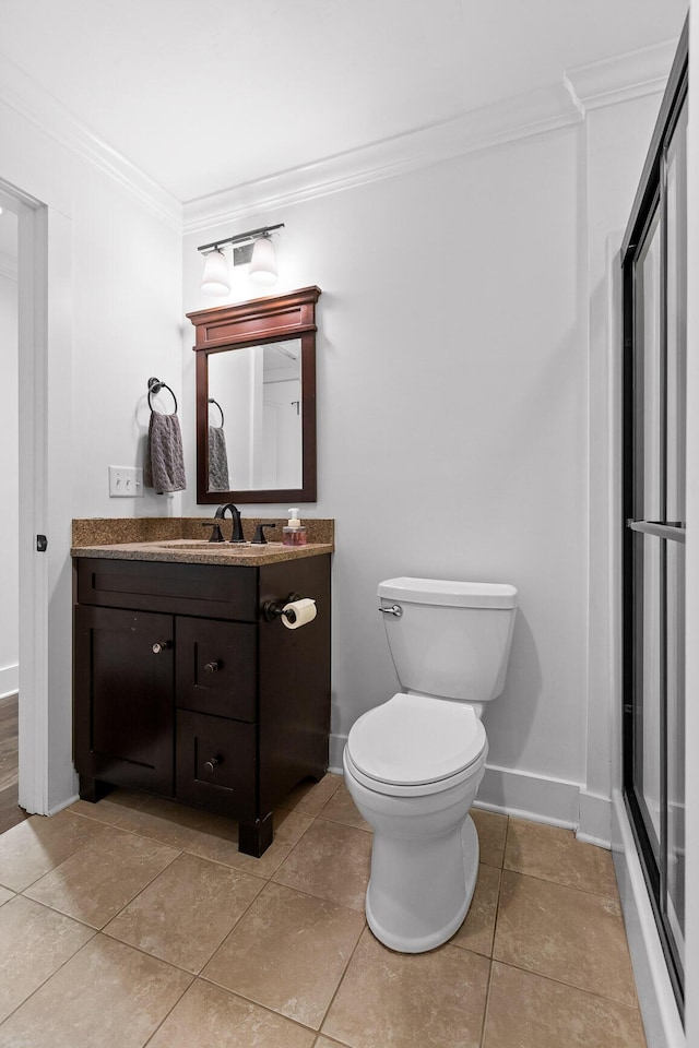 bathroom with tile patterned flooring, toilet, vanity, baseboards, and crown molding