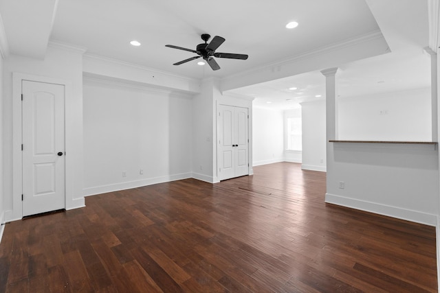 empty room with recessed lighting, ornamental molding, dark wood-type flooring, a ceiling fan, and baseboards