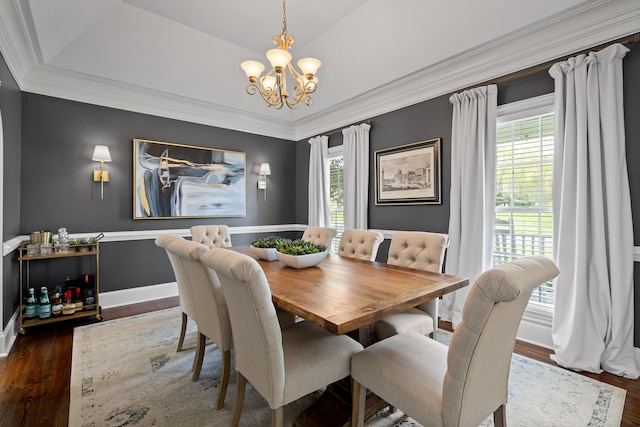 dining room featuring a notable chandelier, wood finished floors, and plenty of natural light
