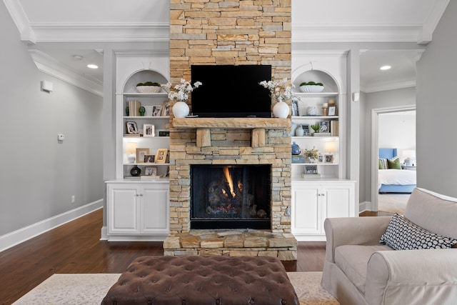 living room with baseboards, a fireplace, dark wood-type flooring, and ornamental molding