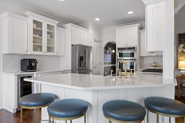 kitchen with white cabinets, stainless steel appliances, and a sink