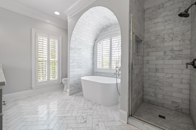full bath featuring a wealth of natural light, ornamental molding, a freestanding tub, and a stall shower