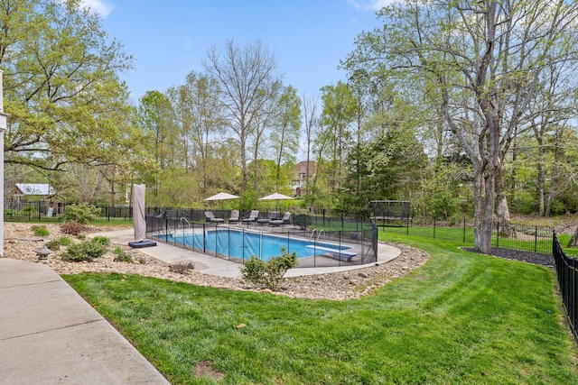 view of pool with a fenced in pool, a lawn, and fence
