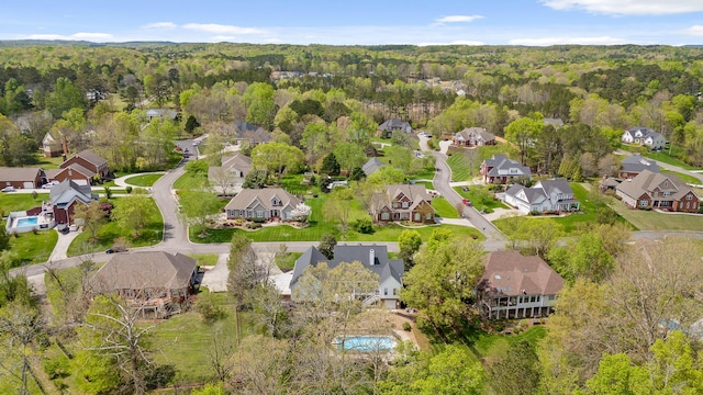 bird's eye view featuring a forest view and a residential view