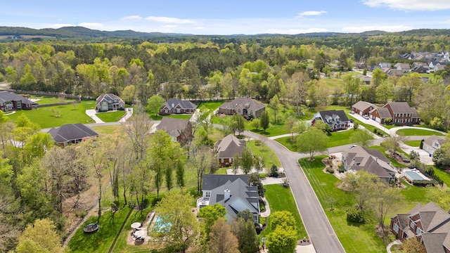 birds eye view of property with a residential view and a view of trees