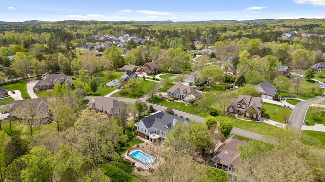 bird's eye view featuring a residential view and a wooded view