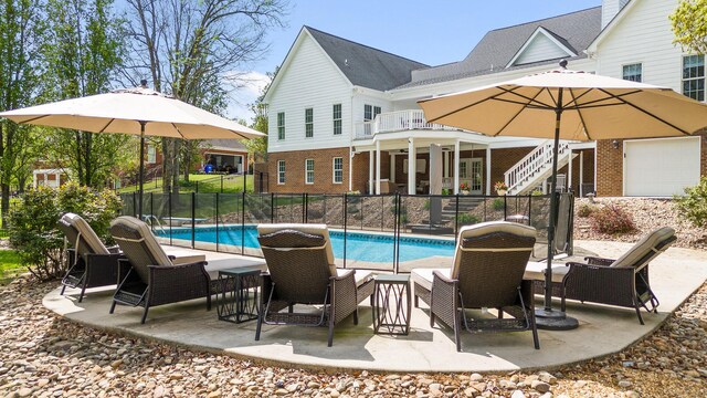 view of swimming pool featuring stairway, a patio area, a fenced in pool, and fence