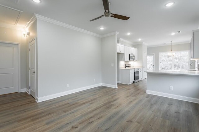 186 Andros Dr Unit 20D, Dalton, GA 30721 - unfurnished living room featuring ceiling fan with notable chandelier, dark wood-type flooring, ornamental molding, and sink