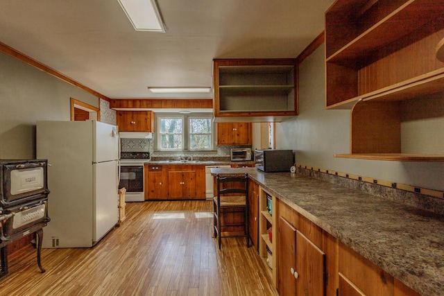 kitchen with white appliances, under cabinet range hood, open shelves, and light wood-style floors