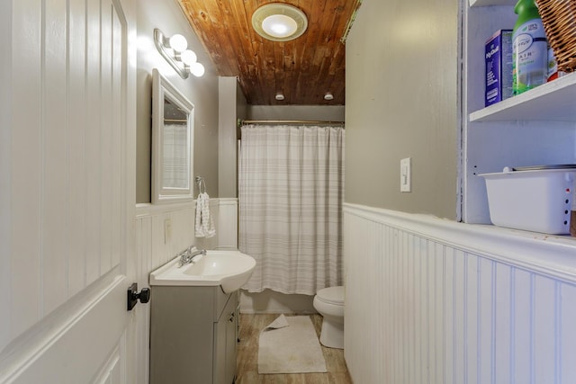 full bathroom featuring toilet, a wainscoted wall, wood ceiling, and vanity