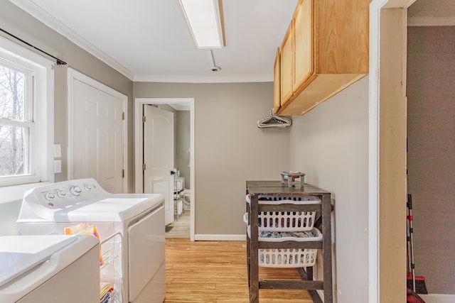 laundry area with separate washer and dryer, baseboards, light wood-type flooring, cabinet space, and crown molding