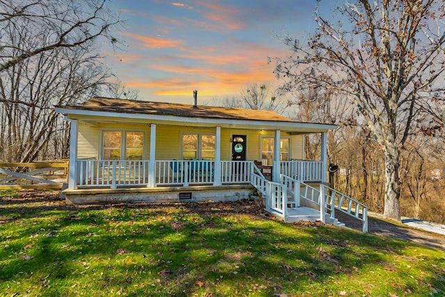 view of front of property with a porch, crawl space, and a front lawn