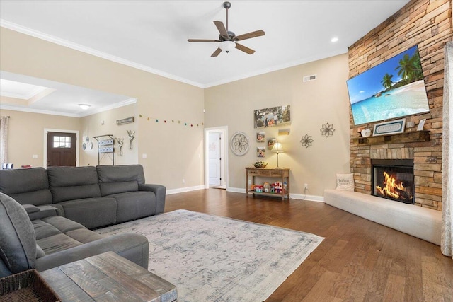 55 E Acorn Dr, Rock Spring, GA 30739 - living area with a ceiling fan, wood finished floors, a stone fireplace, crown molding, and baseboards