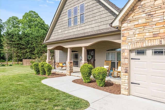 55 E Acorn Dr, Rock Spring, GA 30739 - entrance to property with a porch, stone siding, a lawn, and a garage