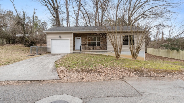 ranch-style home with an attached garage, covered porch, driveway, and fence