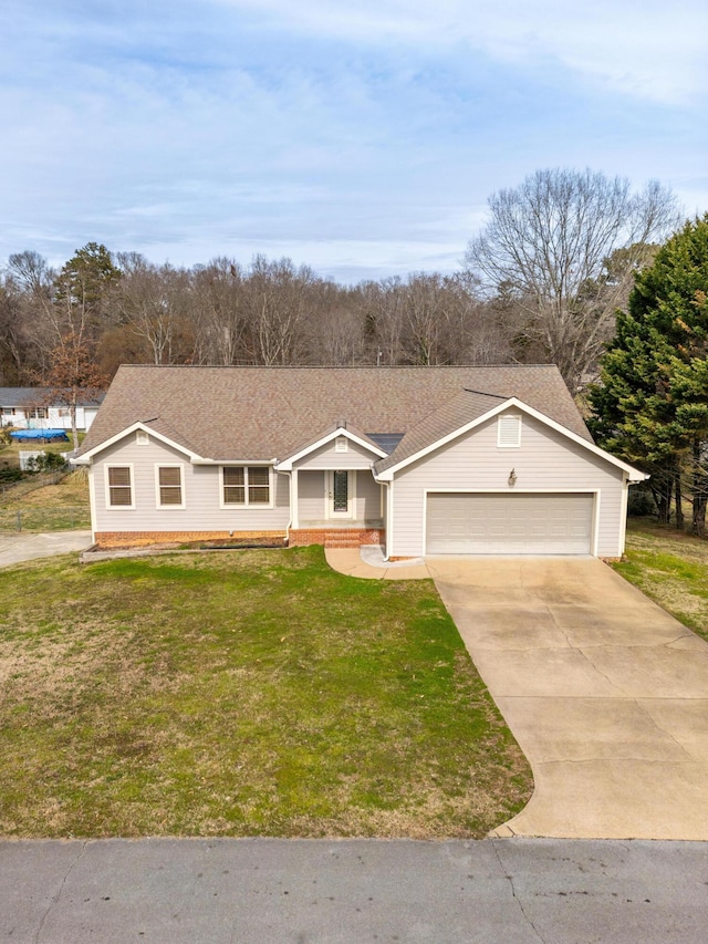 ranch-style house featuring an attached garage, driveway, roof with shingles, and a front yard