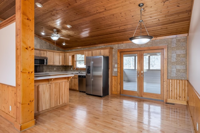 kitchen featuring a wainscoted wall, wood ceiling, light countertops, appliances with stainless steel finishes, and pendant lighting