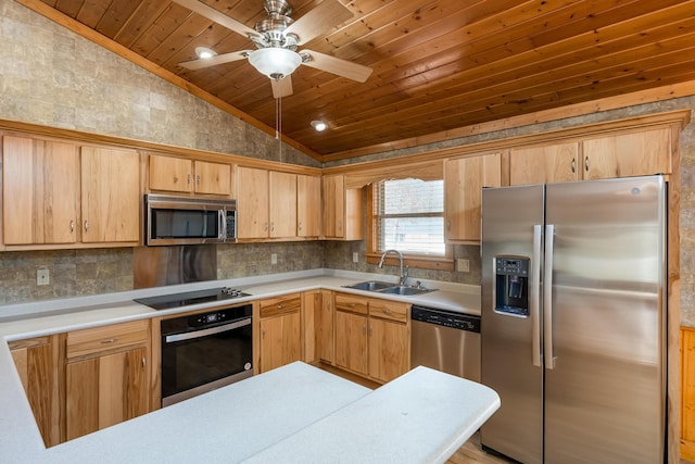 kitchen with lofted ceiling, stainless steel appliances, a sink, and light countertops