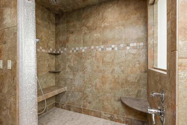 bathroom with tiled shower