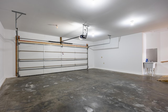 garage with baseboards and a garage door opener