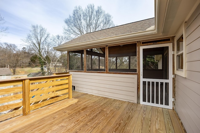 wooden deck featuring a sunroom