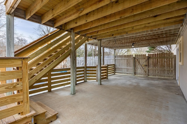 snow covered patio featuring fence