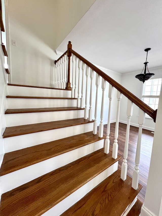 stairs with baseboards and wood finished floors