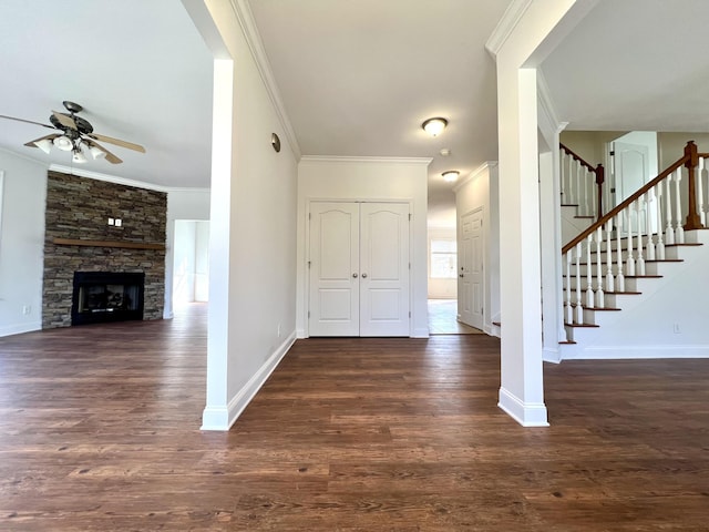 foyer entrance with dark wood-type flooring, a ceiling fan, baseboards, ornamental molding, and stairway