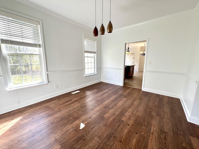 empty room with crown molding, visible vents, dark wood finished floors, and baseboards