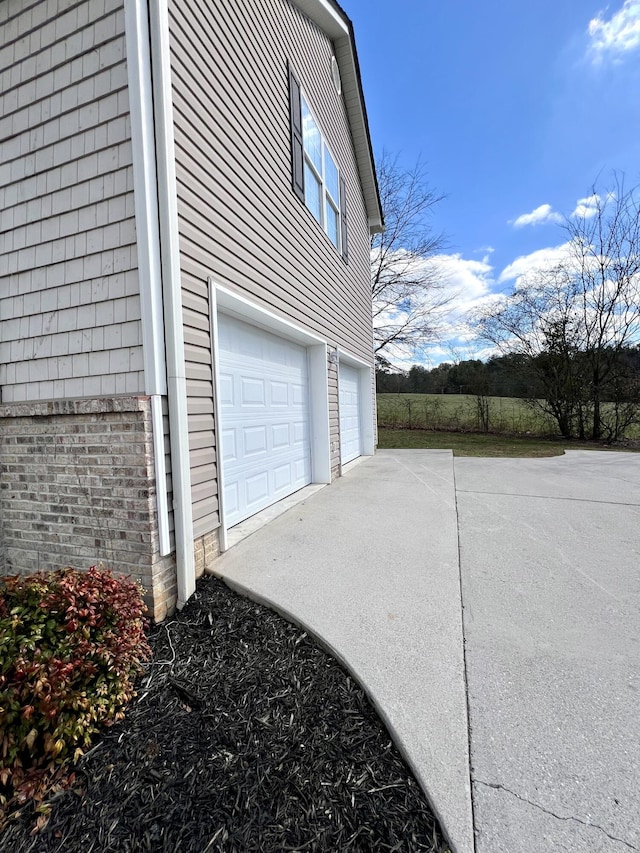 garage with concrete driveway