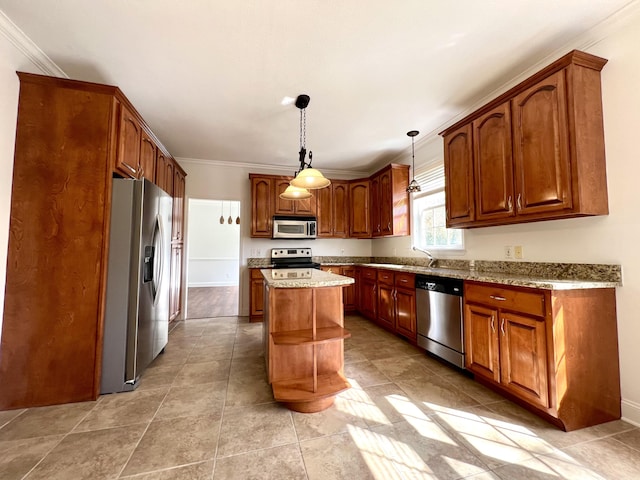 kitchen with pendant lighting, stainless steel appliances, brown cabinets, and a center island