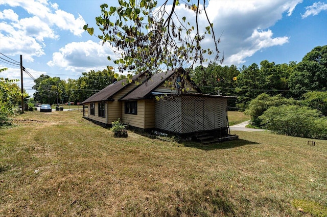 view of side of home featuring a yard