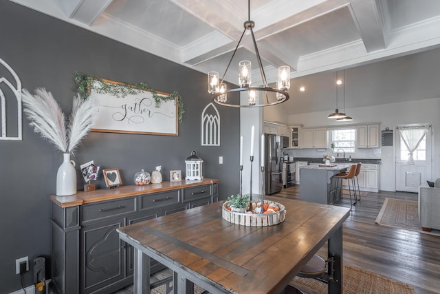 dining room with coffered ceiling, dark wood finished floors, beamed ceiling, crown molding, and a chandelier