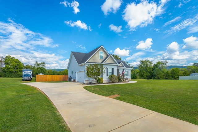 view of front facade with a garage, a front yard, concrete driveway, and fence