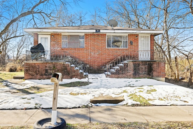 bungalow-style house with brick siding