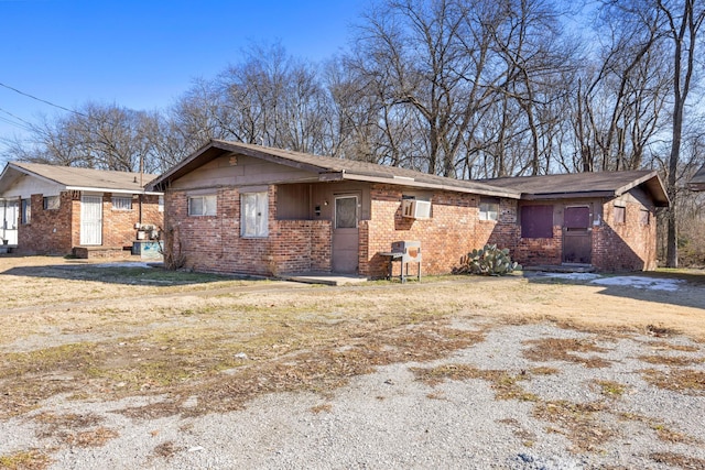 view of front of house with a front yard and brick siding