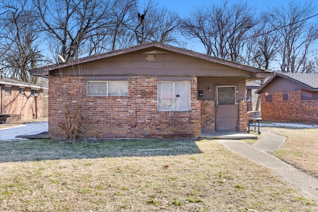 view of front of house featuring a front yard and brick siding