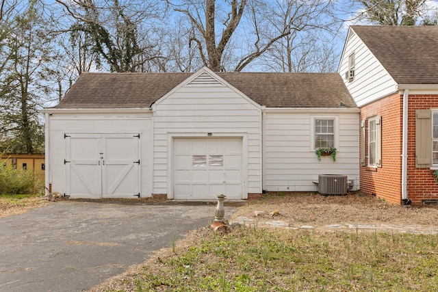 exterior space featuring central air condition unit and aphalt driveway