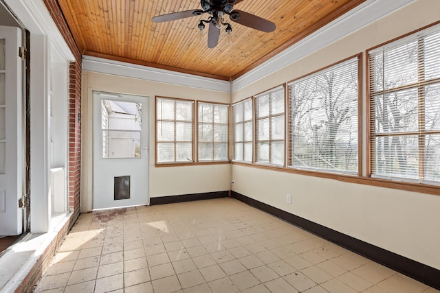 unfurnished sunroom with a wealth of natural light, wooden ceiling, and ceiling fan