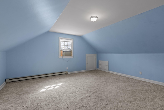 additional living space featuring vaulted ceiling, carpet flooring, baseboards, and a baseboard radiator