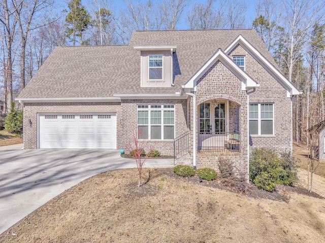 view of front facade with a garage, concrete driveway, a shingled roof, and brick siding