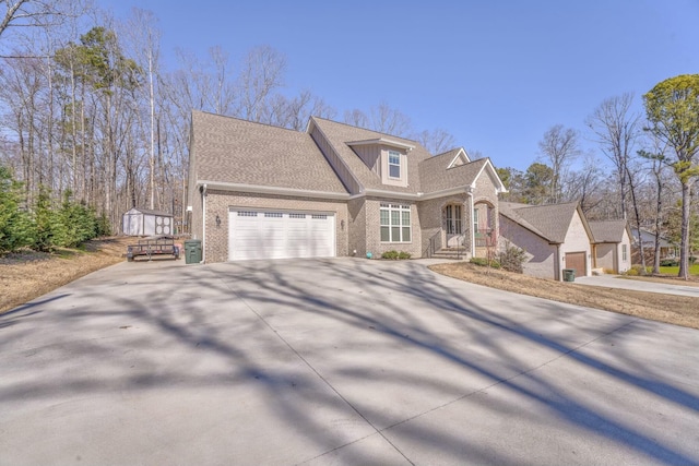 view of front facade featuring a garage, driveway, a shingled roof, and brick siding