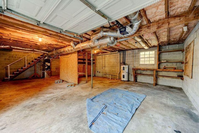 garage with water heater and a garage door opener