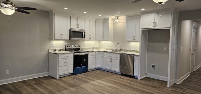 kitchen featuring stainless steel appliances, white cabinets, dark wood finished floors, and light stone countertops