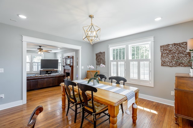 dining space featuring light wood-type flooring, baseboards, and recessed lighting